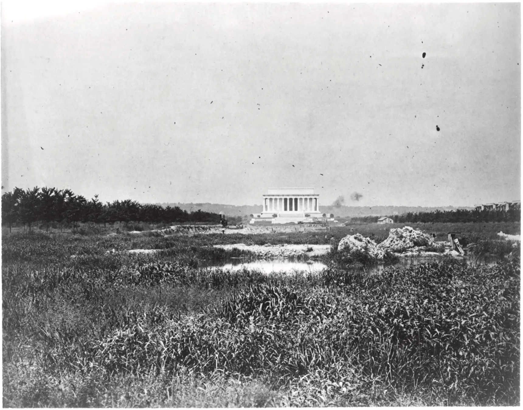Early 20th century photo of the Lincoln Memorial with a marsh in the foreground.